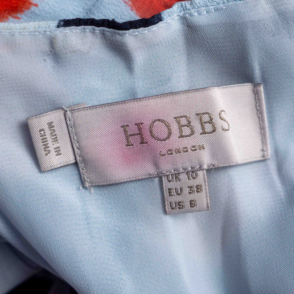 Hobbs London blue multicolour polka dot dress with ruffle hem and fitted waist.