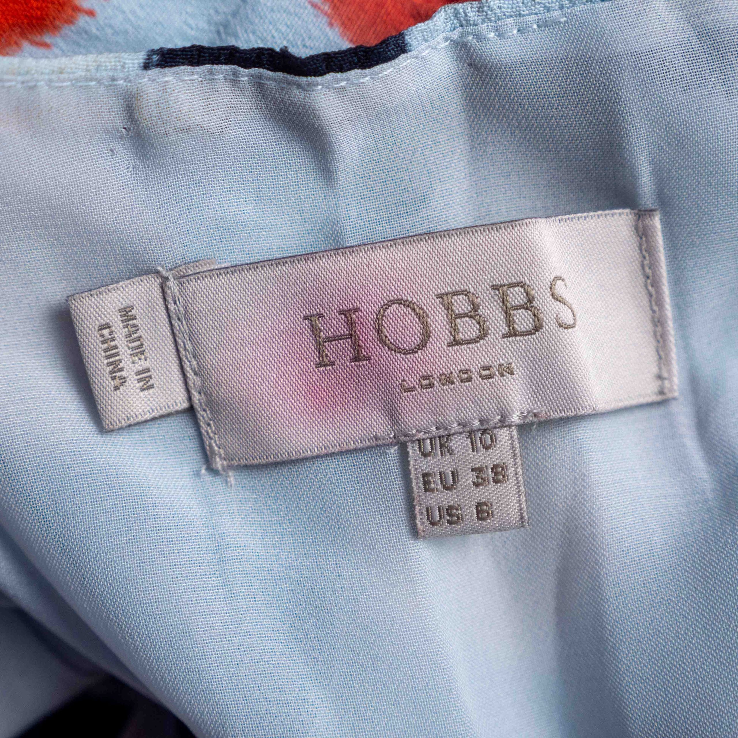 Hobbs London blue multicolour polka dot dress with ruffle hem and fitted waist.