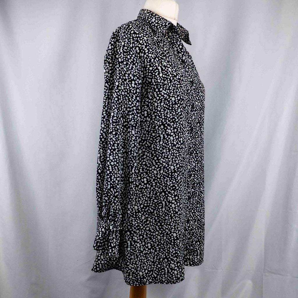 Missguided black and white spot print shirt with button-down front and flared cuffs.