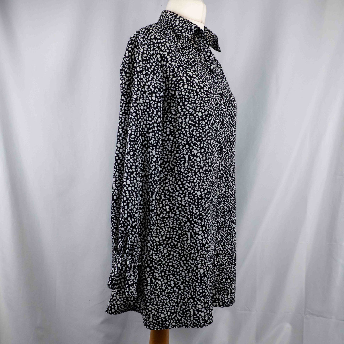 Missguided black and white spot print shirt with button-down front and flared cuffs.