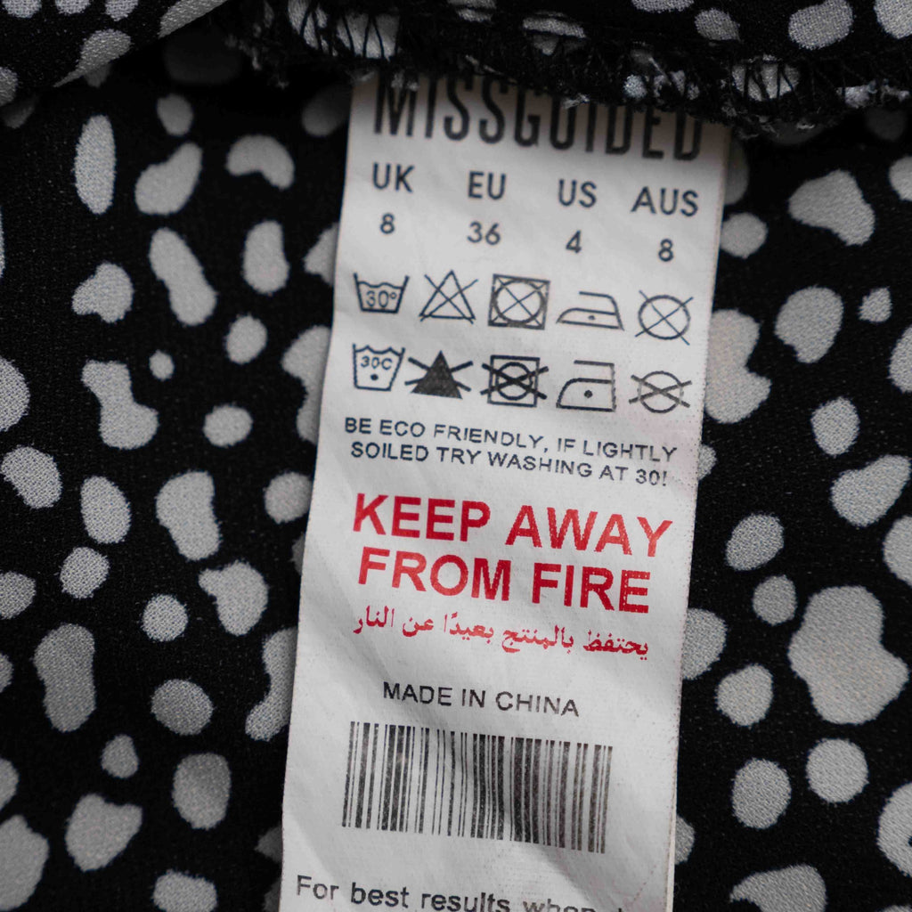 Missguided black and white spot print shirt with button-down front and flared cuffs.