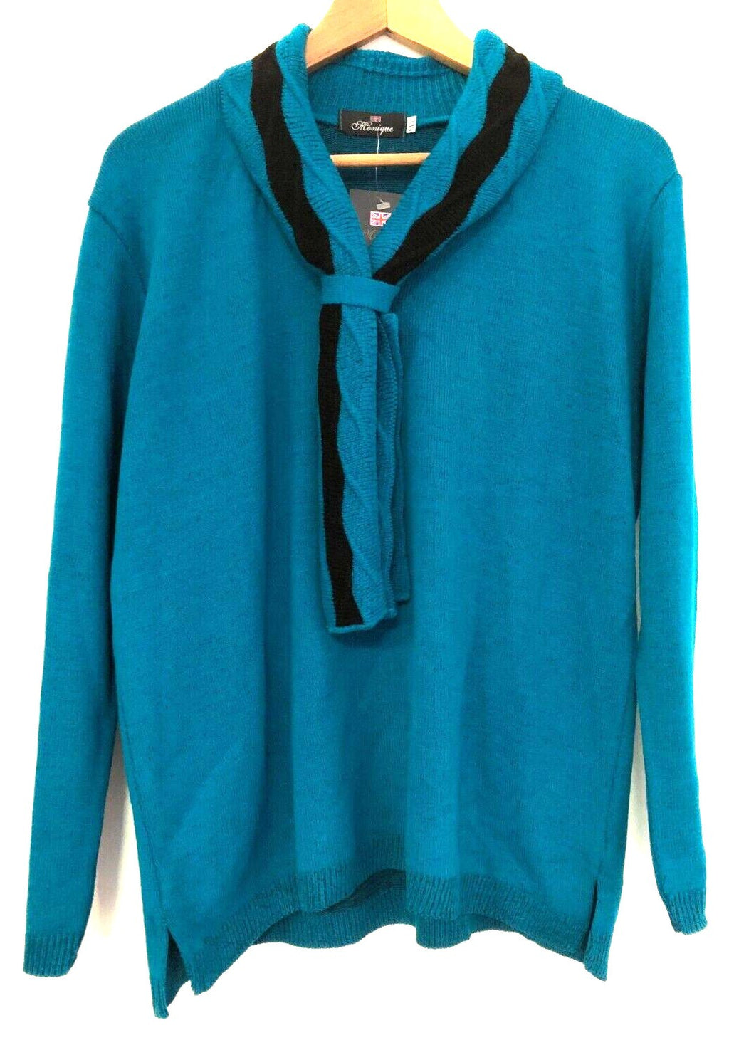 Monique green crewneck sweater with black mock scarf detail and toggle fastening.