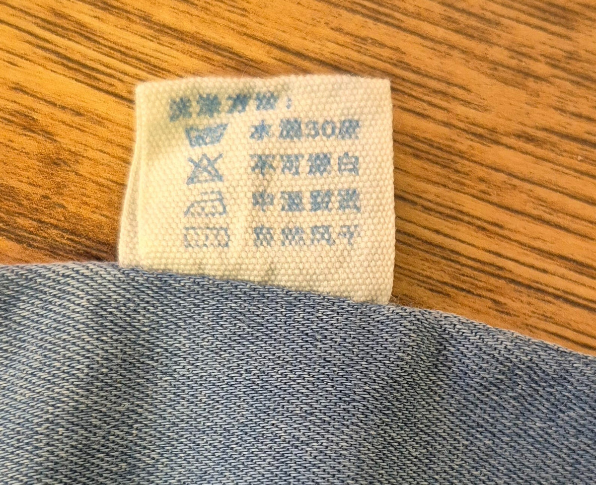 Lingxibeier blue denim jumpsuit with giraffe pattern, long sleeves, and front pockets.
