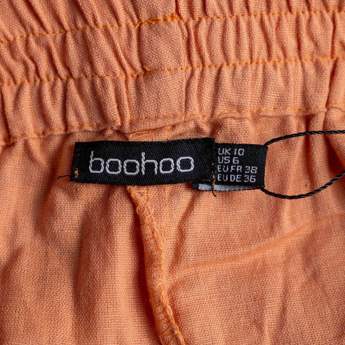 Boohoo orange linen ruffle shorts with lace trim and elasticated waistband.