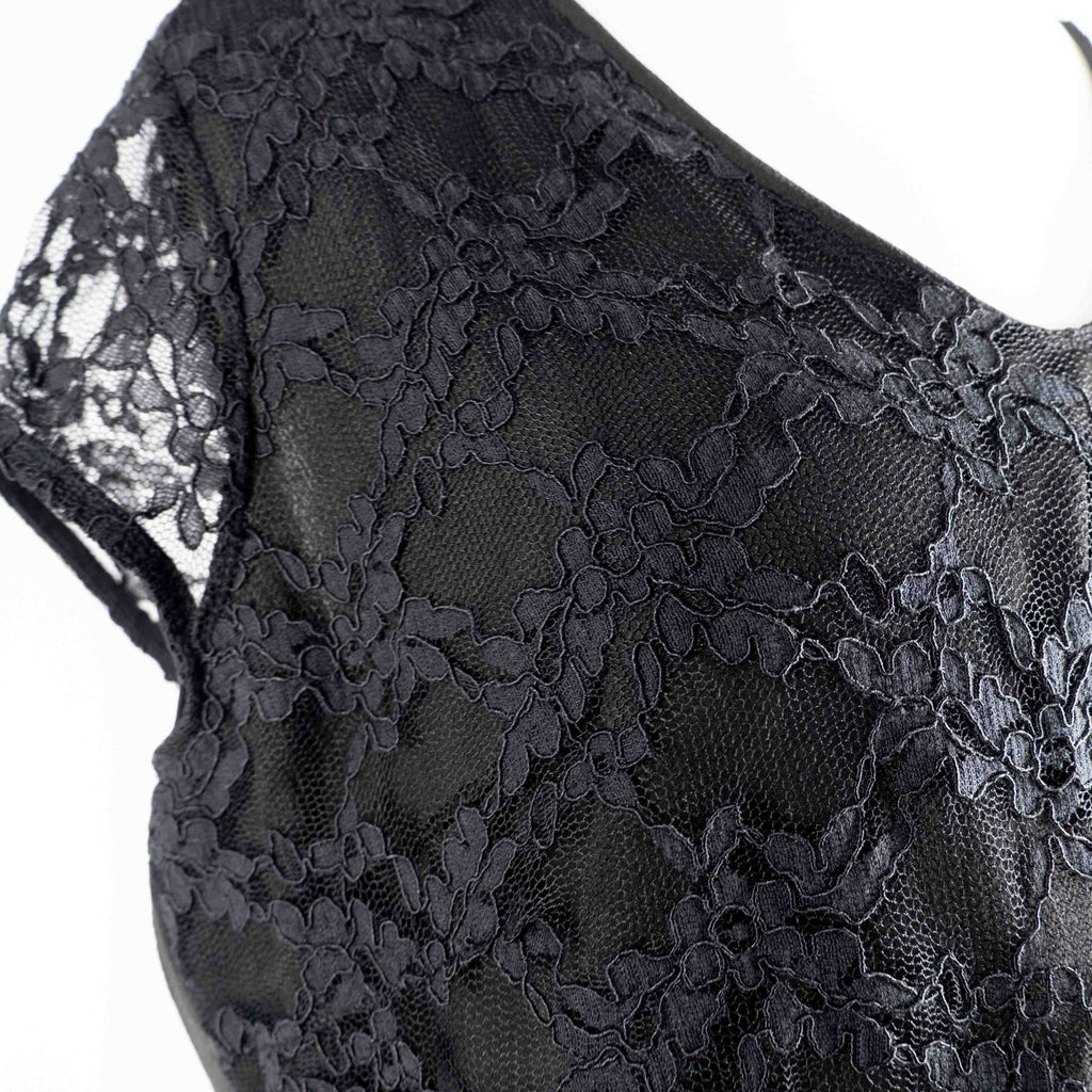 Black lace sleeve top with V neckline and tie-back detail, feminine style.