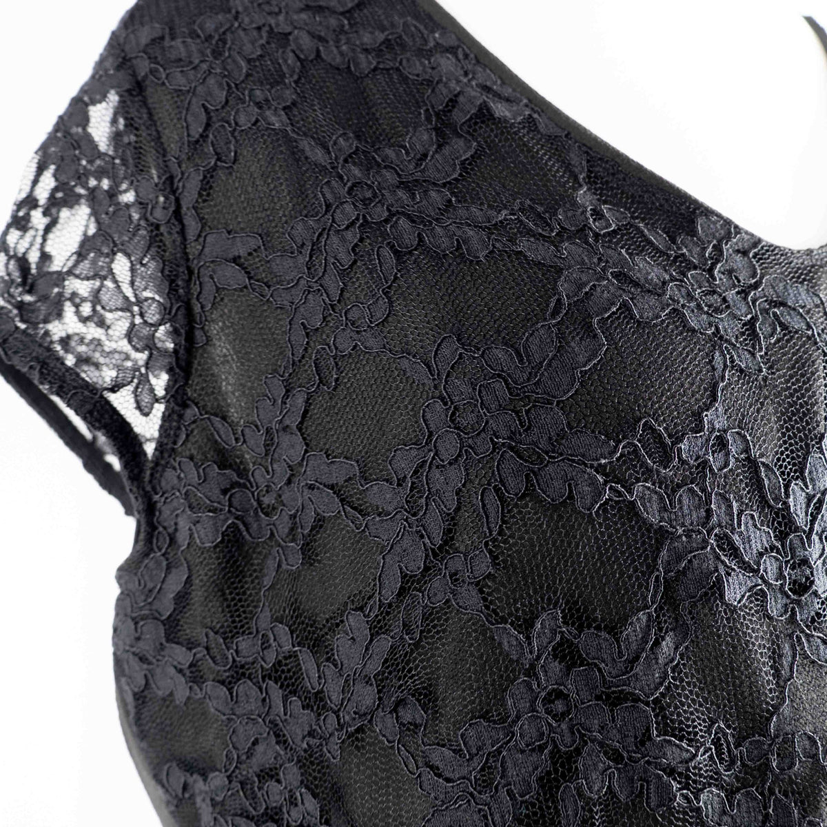 Black lace sleeve top with V neckline and tie-back detail, feminine style.