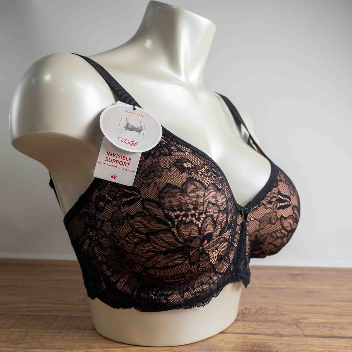 Triumph black lace bra with elegant overlay, underwired, adjustable straps, brand new with tags.
