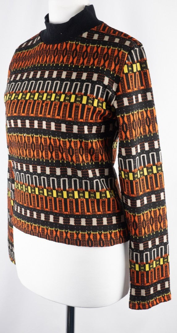 Zara black crewneck sweater with orange, yellow, and cream geometric pattern.