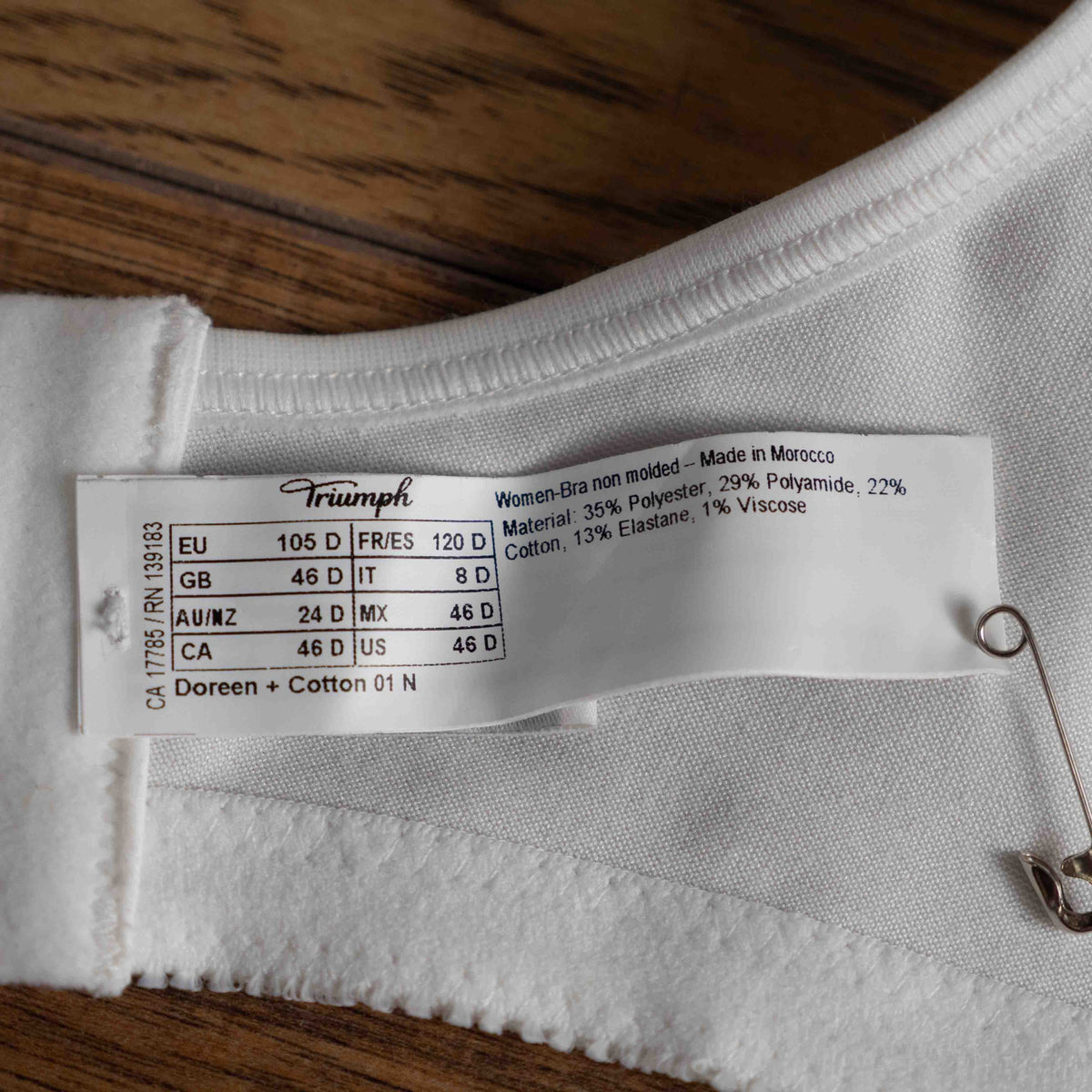 Triumph white blend bra with delicate embroidery, adjustable straps, and hook-and-eye closure.