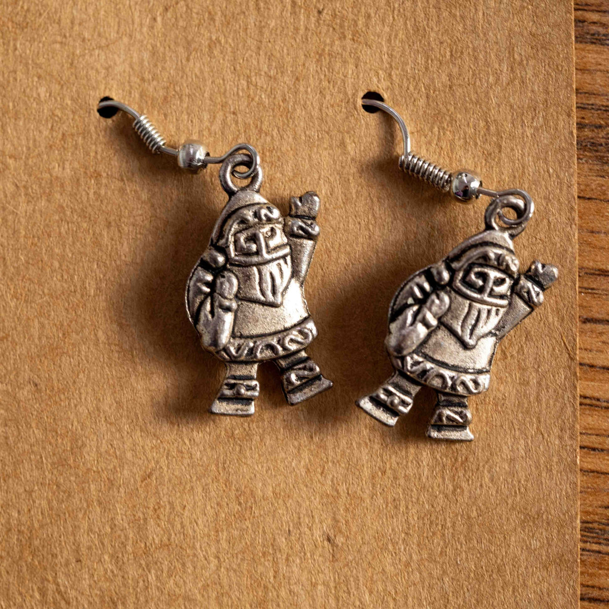 Silver earrings featuring detailed Santa Claus charms in a festive design.