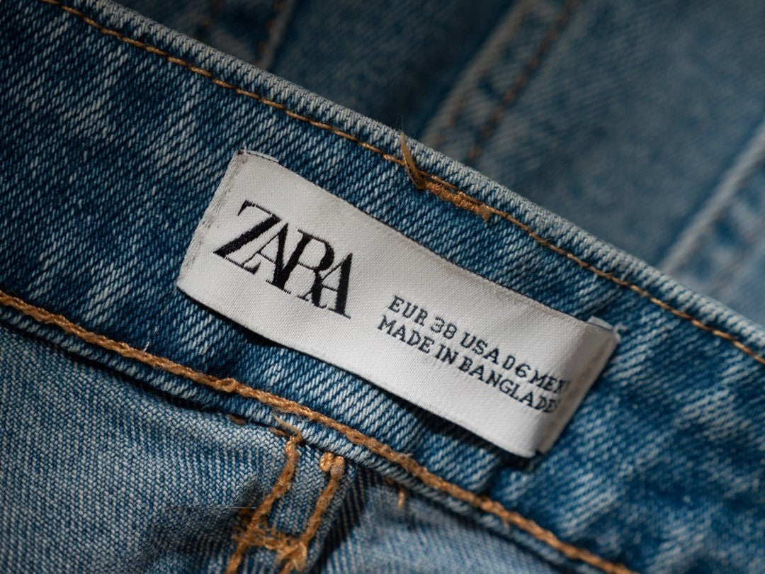 Zara blue frayed denim shorts with four pockets and belt loops, size 10.