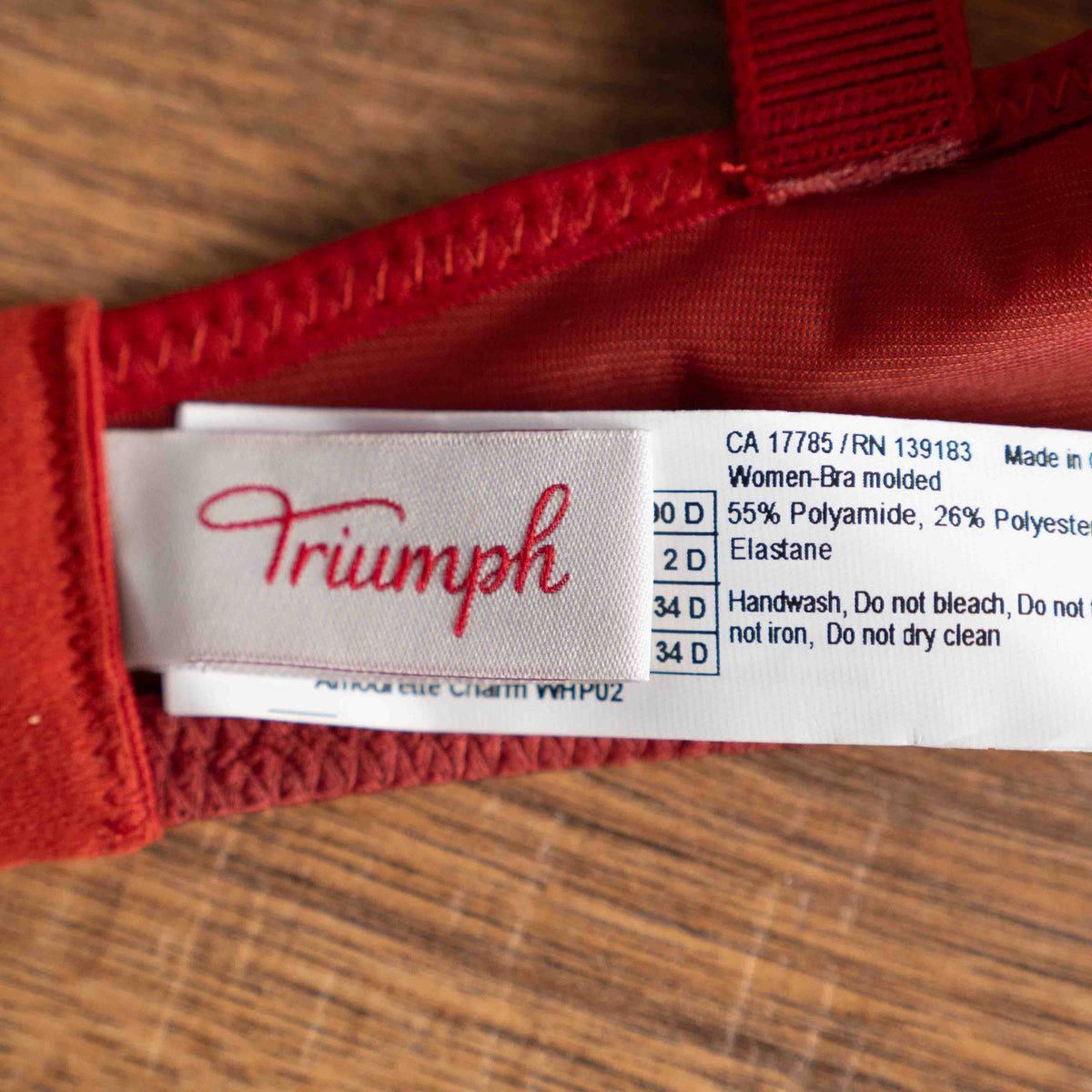 Triumph red lace bra with padded cups and adjustable straps, new with tags.