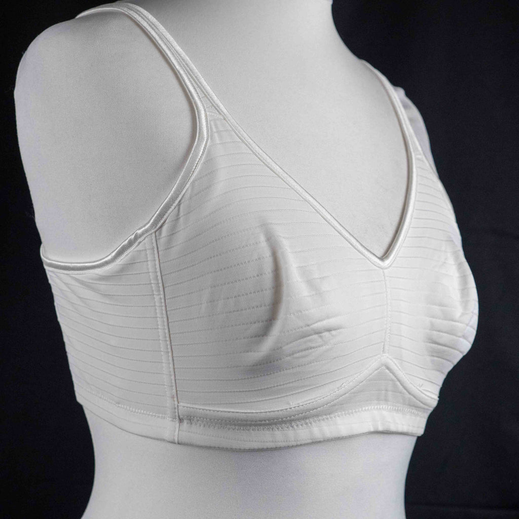Nicola Jane white mastectomy bra with adjustable straps and back hook closure.