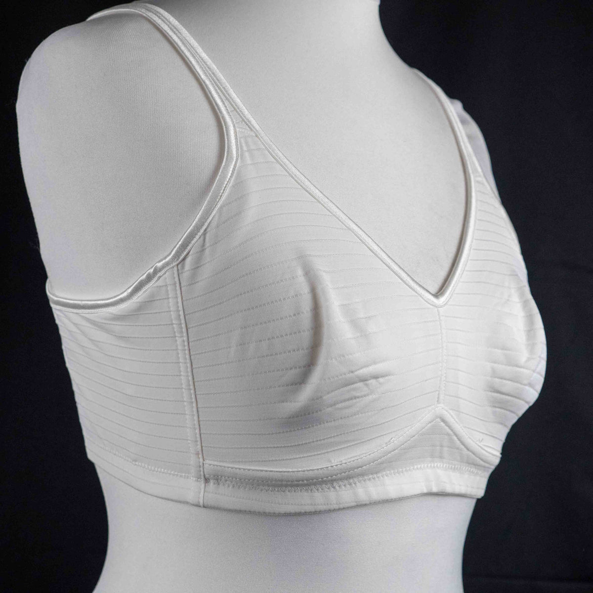 Nicola Jane white mastectomy bra with adjustable straps and back hook closure.
