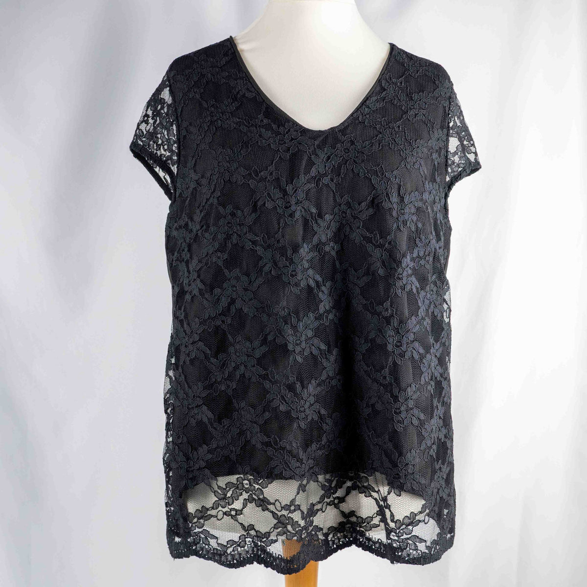 Black lace sleeve top with V neckline and tie-back detail, feminine style.
