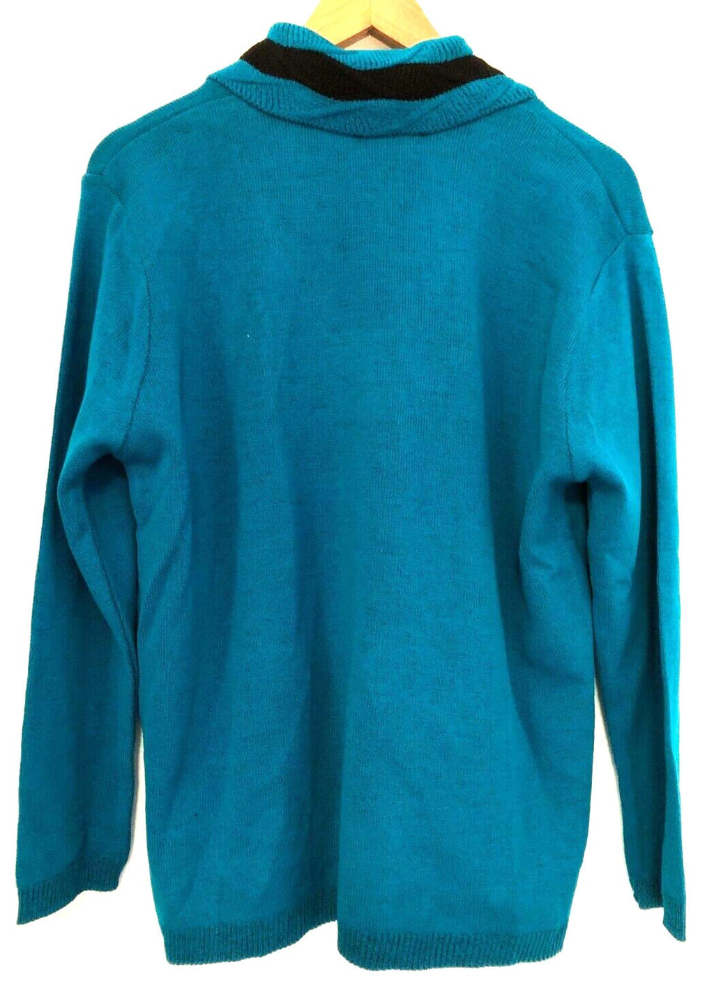 Monique green crewneck sweater with black mock scarf detail and toggle fastening.