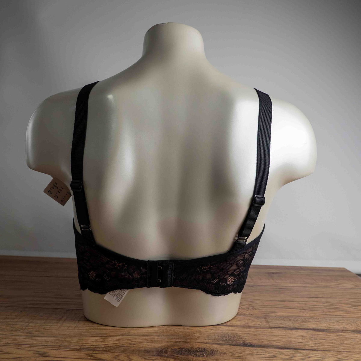 Triumph black lace bra with elegant overlay, underwired, adjustable straps, brand new with tags.