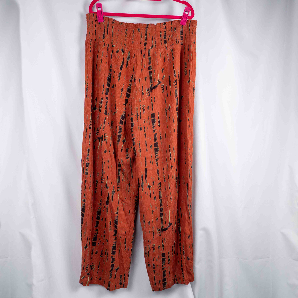 Bodyflirt orange wide-leg trousers with abstract black print and smocked waistband.
