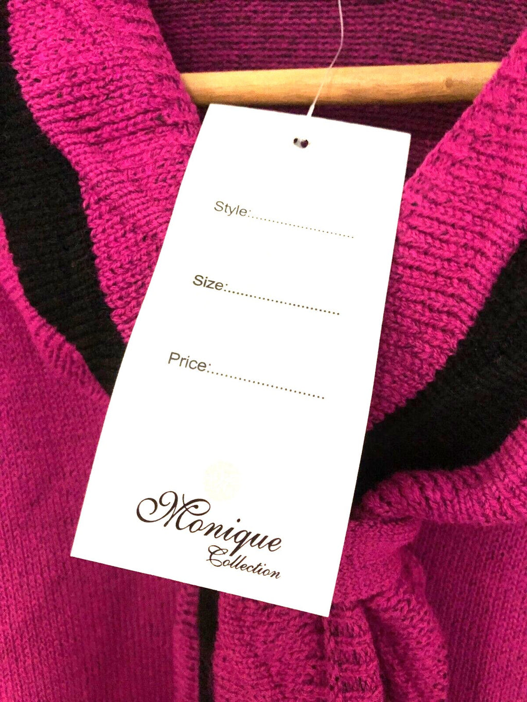 Monique pink crewneck sweater with mock scarf detail and toggle fastening.