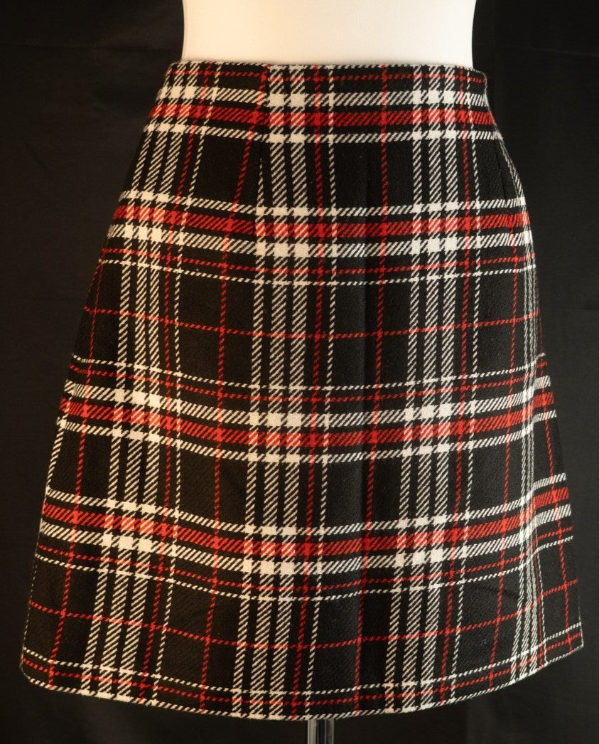Papaya tan mini skirt black, red, and white checked pattern with zip and button closure.