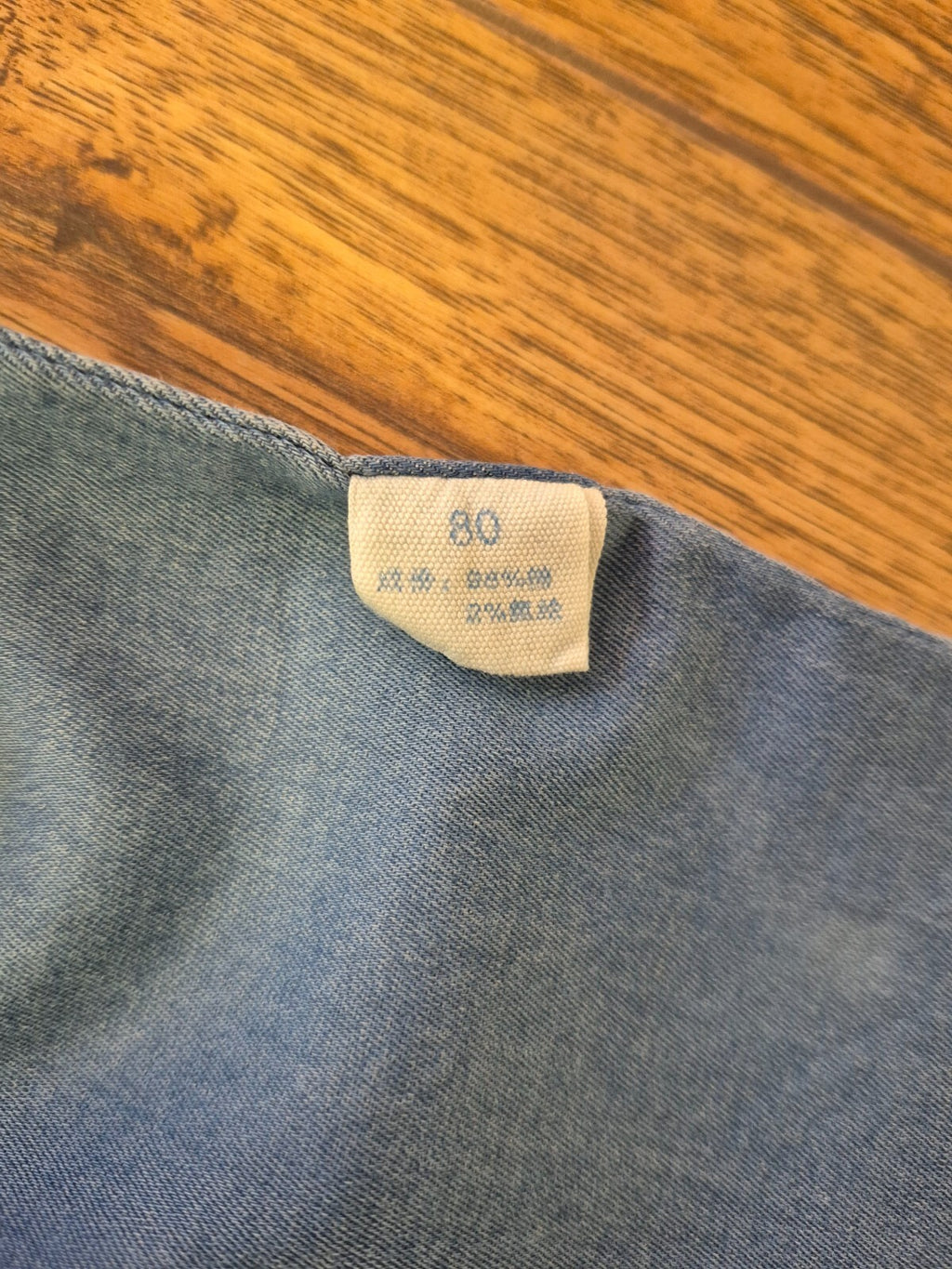 Lingxibeier blue denim jumpsuit with giraffe pattern, long sleeves, and front pockets.