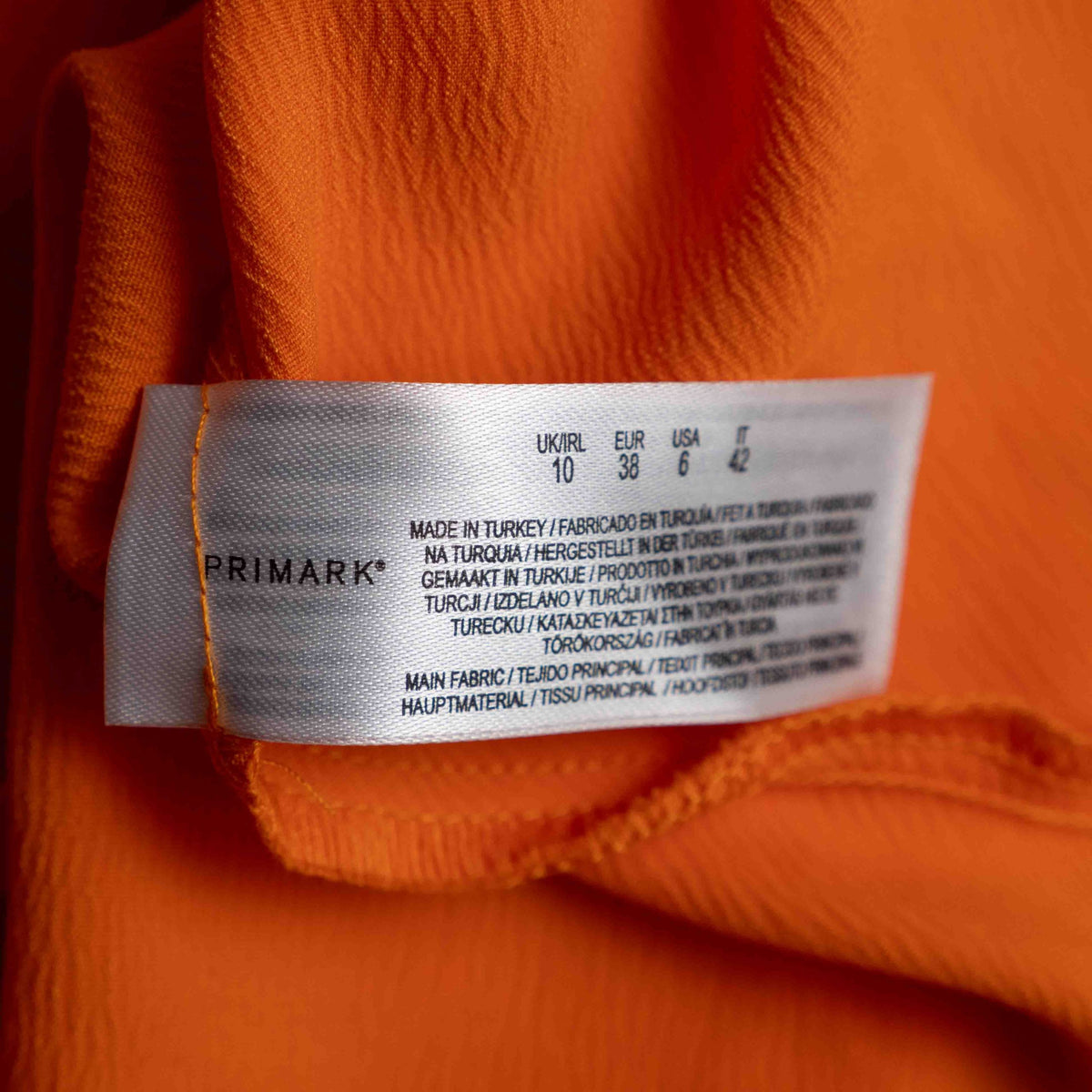 Primark orange slip dress with adjustable spaghetti straps and cowl neckline.