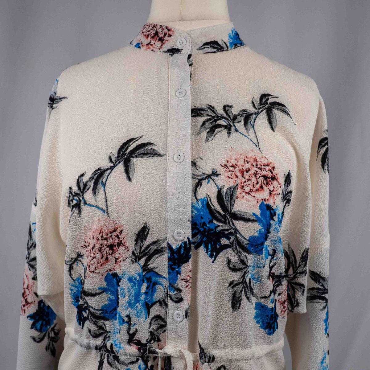 Boohoo white floral blouse with blue and pink prints, button front, drawstring waist.