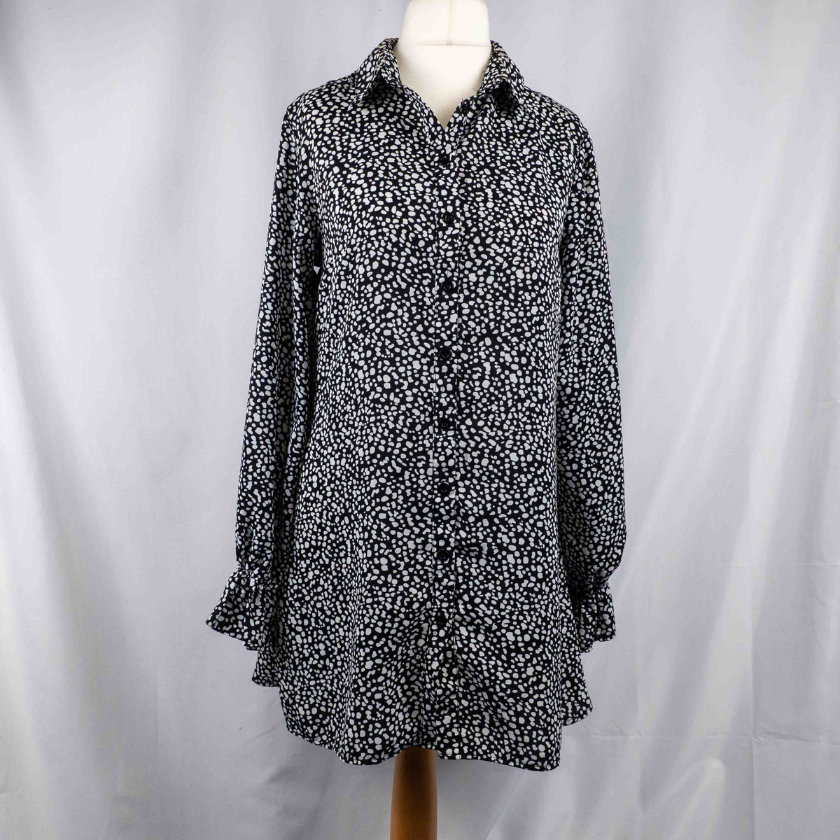 Missguided black and white spot print shirt with button-down front and flared cuffs.