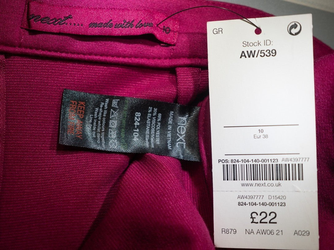 Next pink mini skirt with back zip closure and pleated front, new with tag.