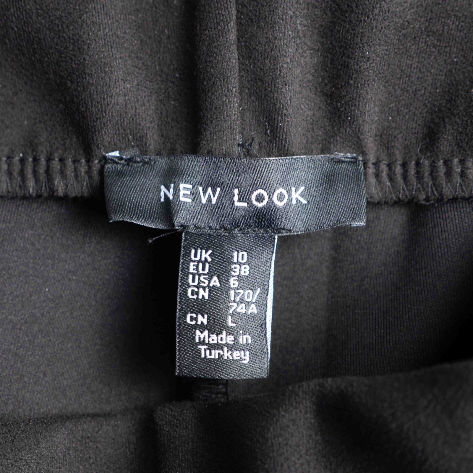 New Look black leggings with elasticated waistband and central line detail, size 10.