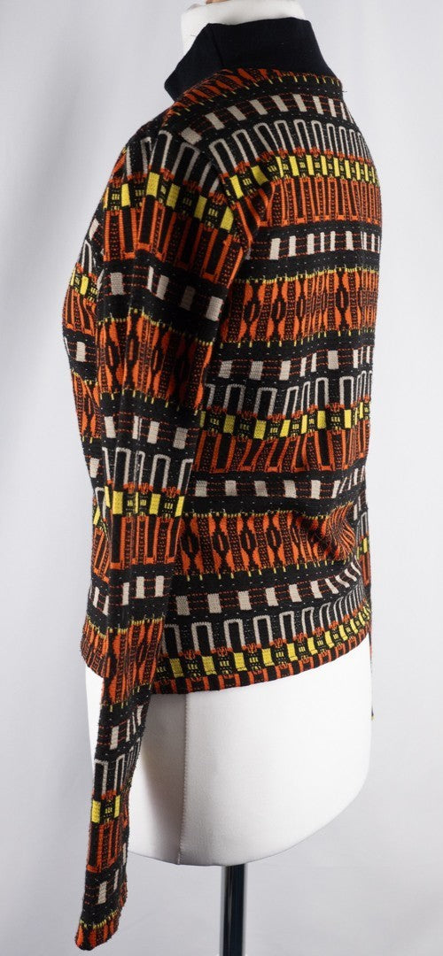 Zara black crewneck sweater with orange, yellow, and cream geometric pattern.