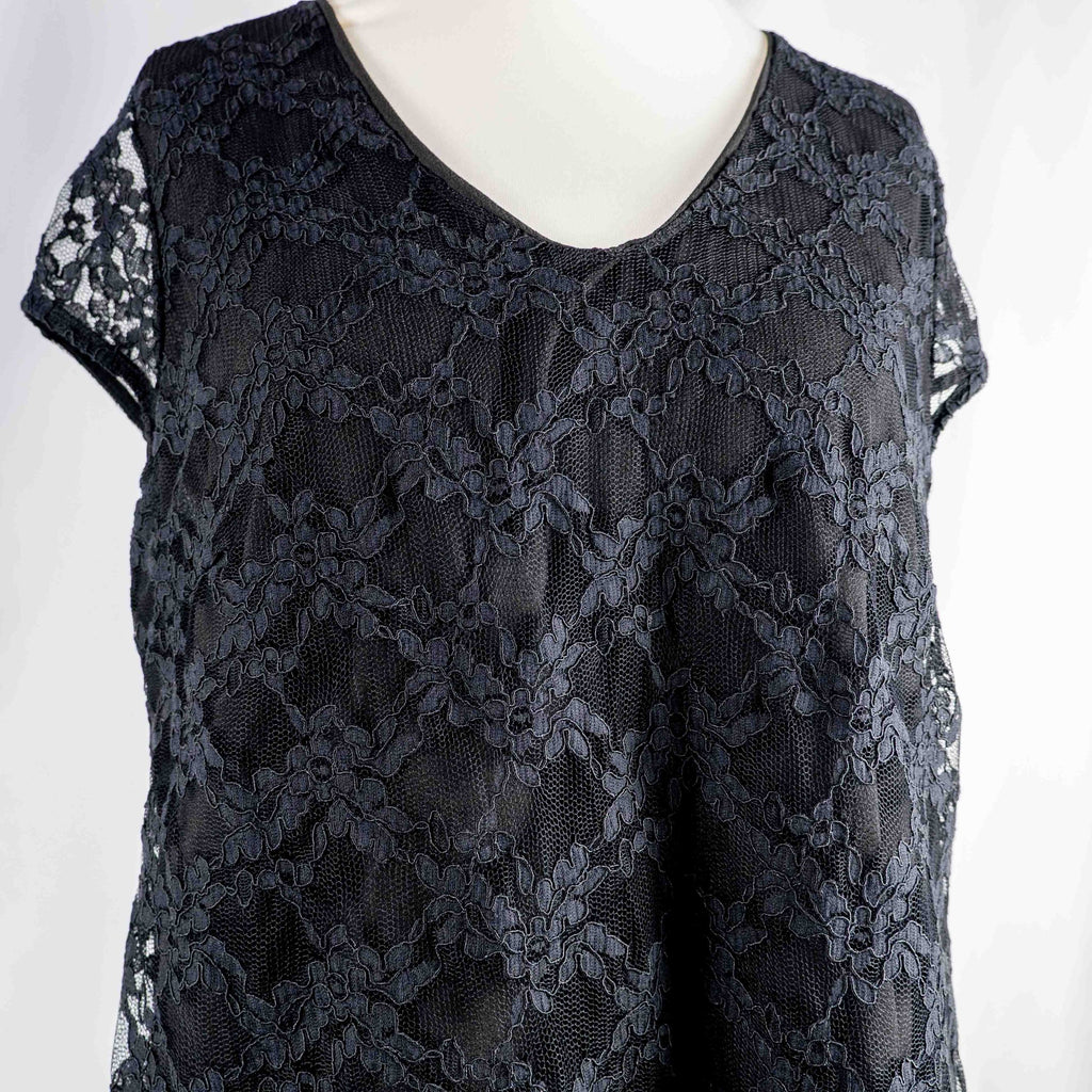 Black lace sleeve top with V neckline and tie-back detail, feminine style.