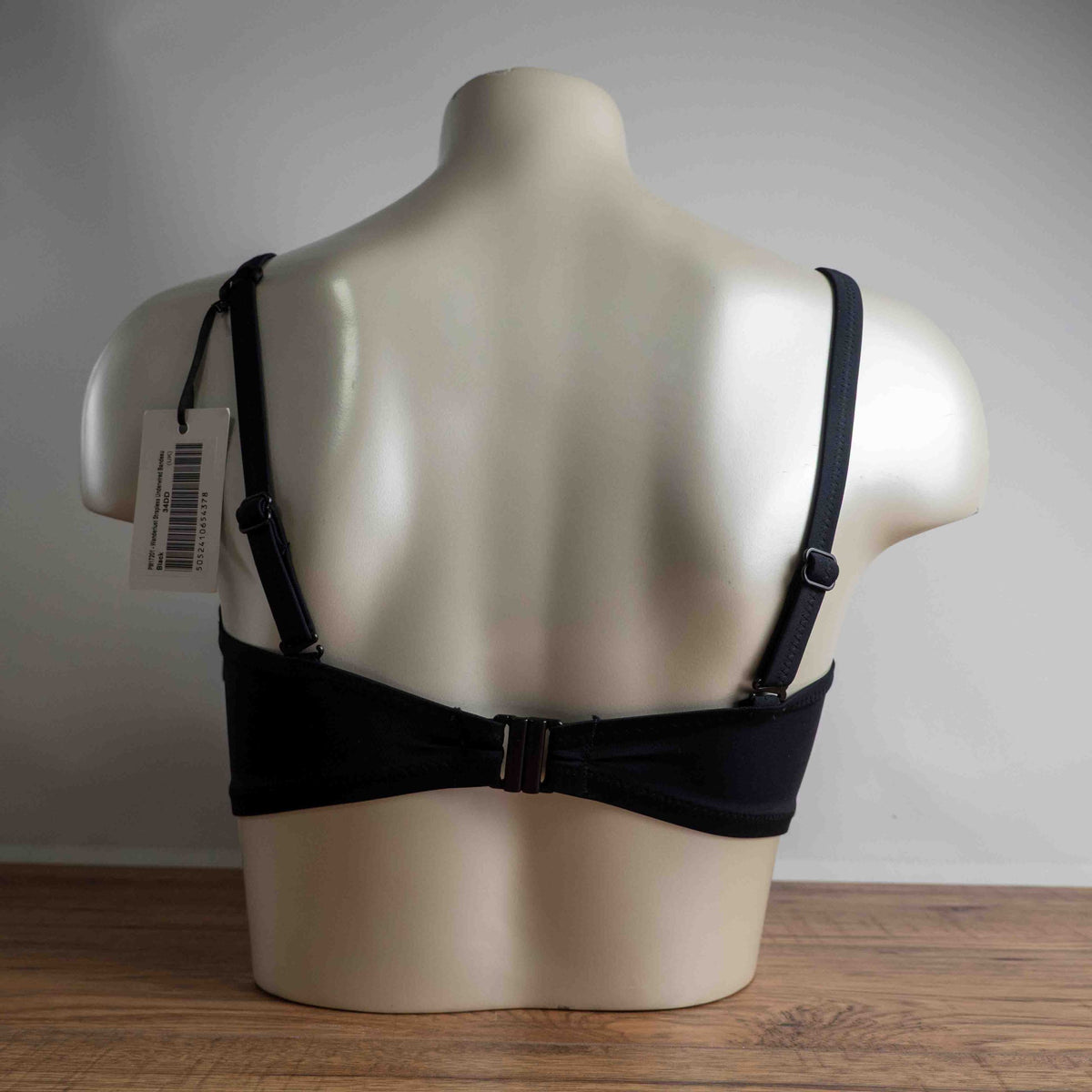 Pour Moi black bikini top with eyelet ruffle detail and adjustable straps.
