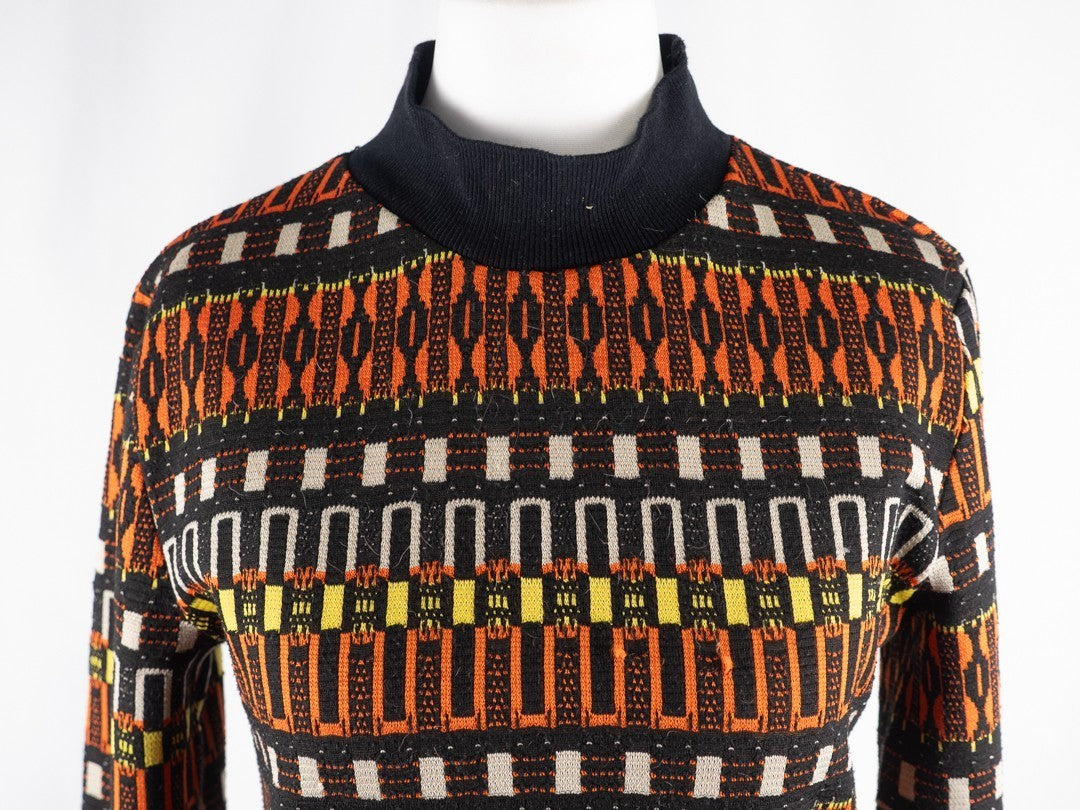 Zara black crewneck sweater with orange, yellow, and cream geometric pattern.