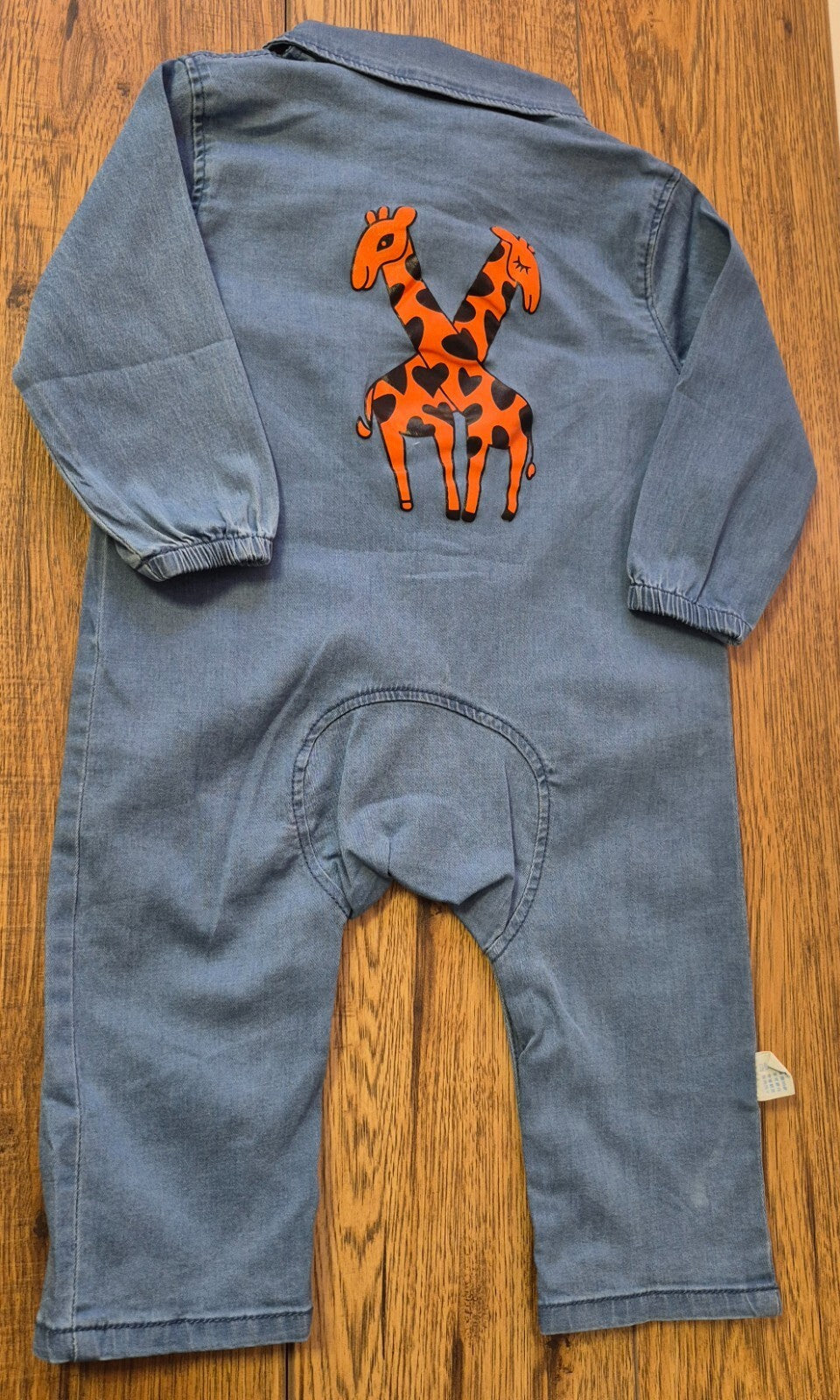 Lingxibeier blue denim jumpsuit with giraffe pattern, long sleeves, and front pockets.