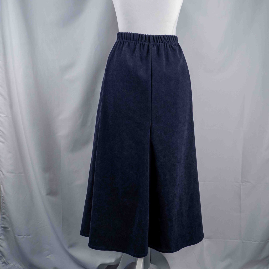 Monique navy velvet long skirt with elastic waistband and flared silhouette.