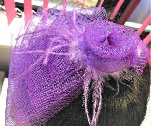 Purple fascinator with feathers and hair clip for special occasions.