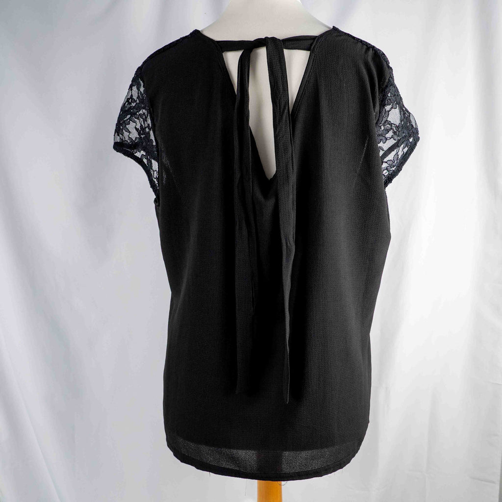 Black lace sleeve top with V neckline and tie-back detail, feminine style.