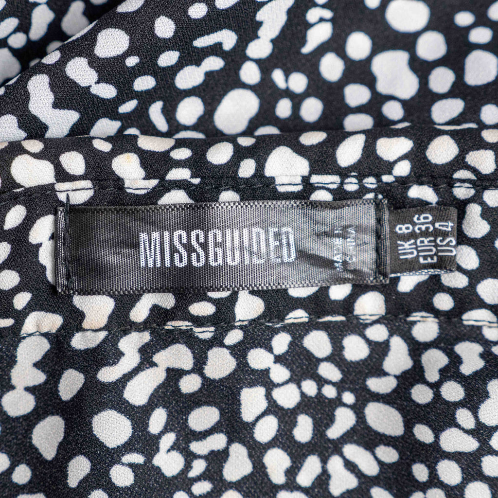 Missguided black and white spot print shirt with button-down front and flared cuffs.