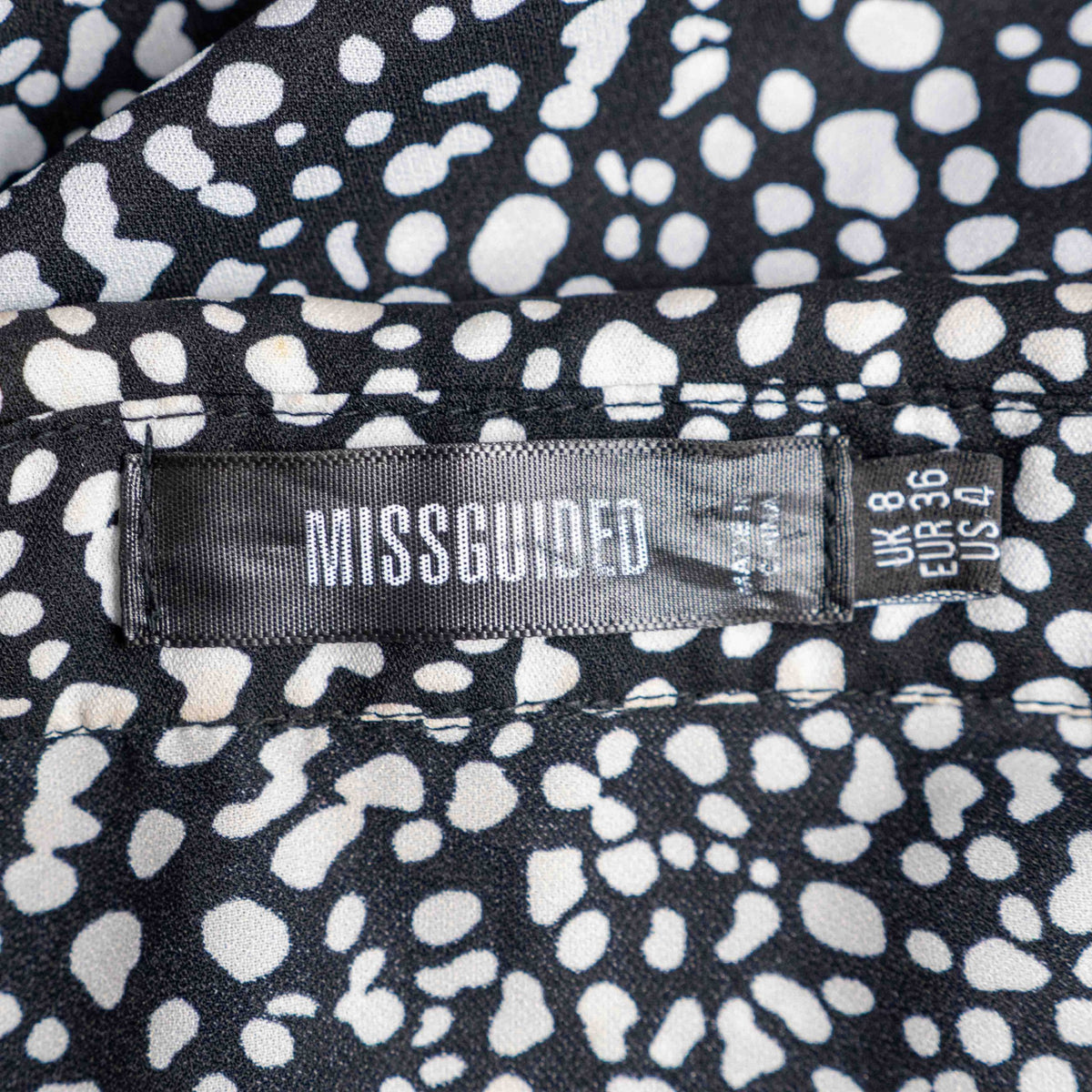 Missguided black and white spot print shirt with button-down front and flared cuffs.
