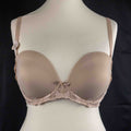 Marks and Spencer beige padded underwired bra with floral lace detail and decorative bow.