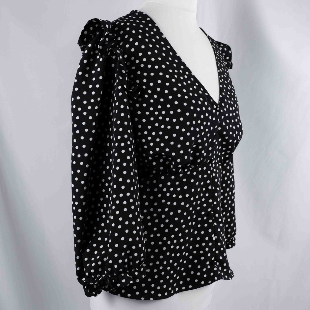 New Look black and white polka dot tunic blouse with V-neck and ruffled sleeves.