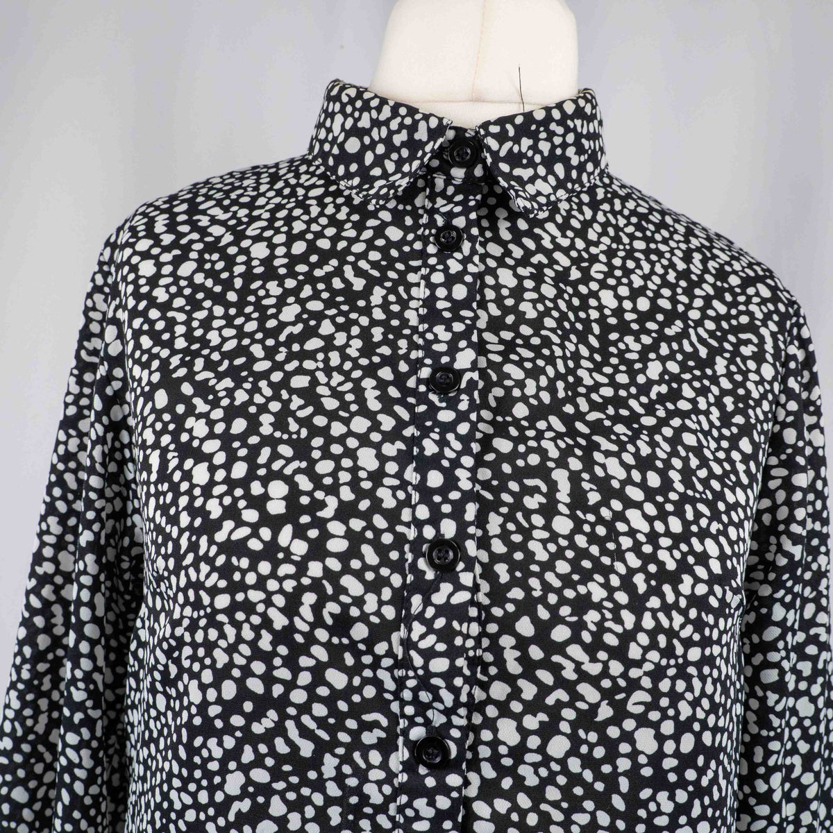 Missguided black and white spot print shirt with button-down front and flared cuffs.
