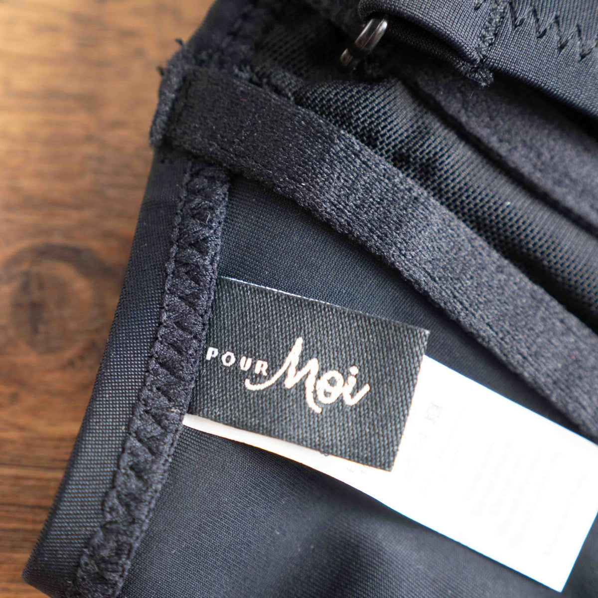 Pour Moi black bikini top with eyelet ruffle detail and adjustable straps.
