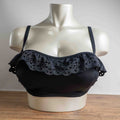 Pour Moi black bikini top with eyelet ruffle detail and adjustable straps.
