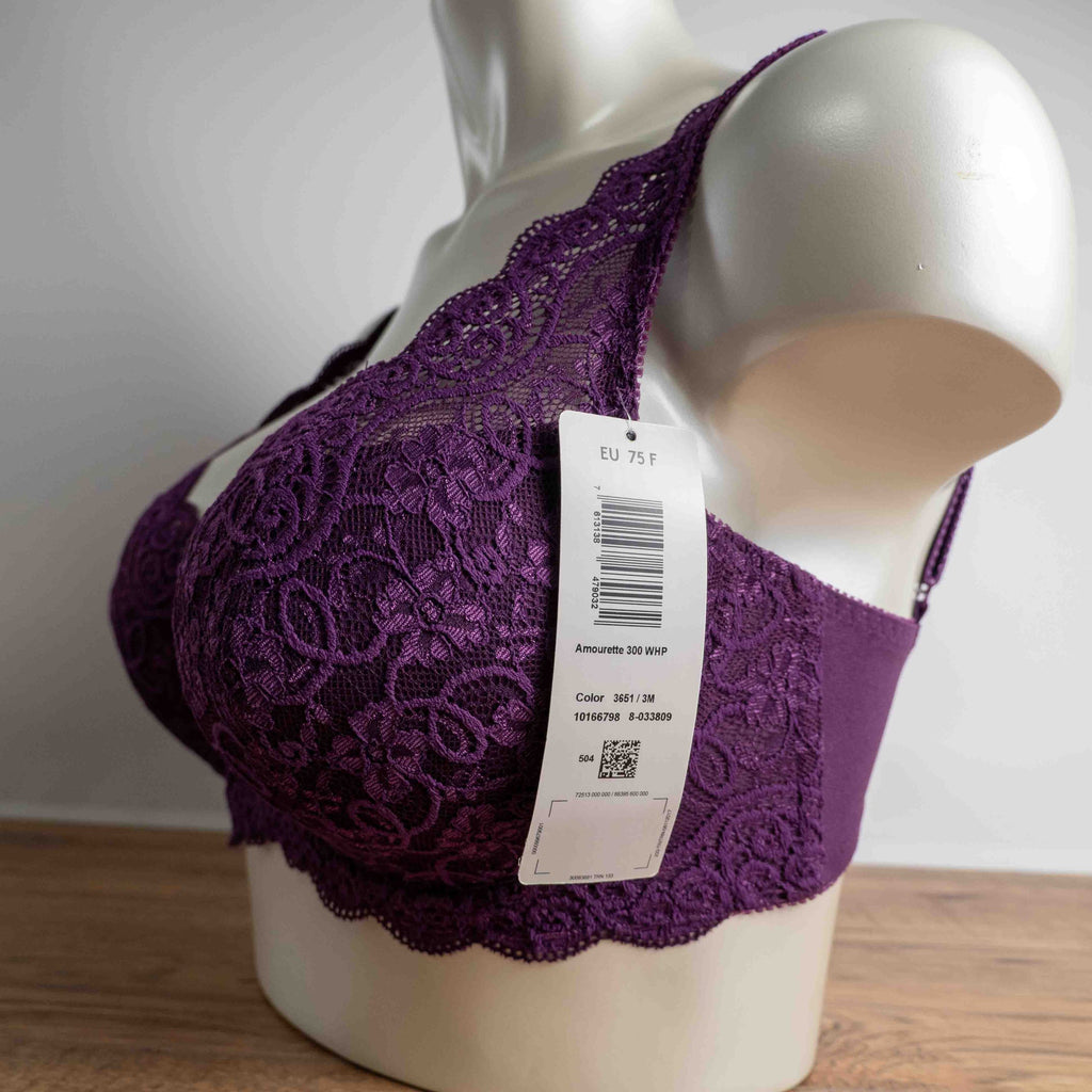 Triumph purple bra with floral lace pattern, adjustable straps, and hook-and-eye closure.