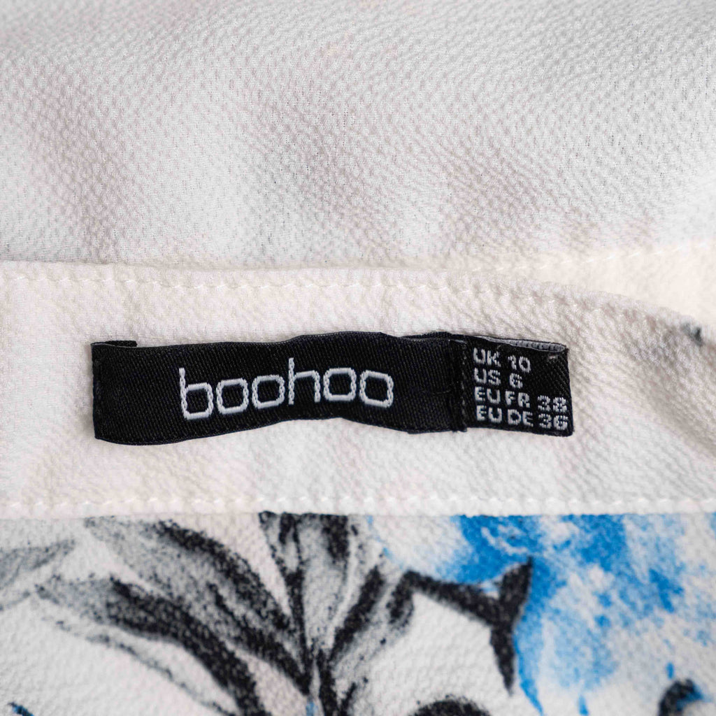 Boohoo white floral blouse with blue and pink prints, button front, drawstring waist.