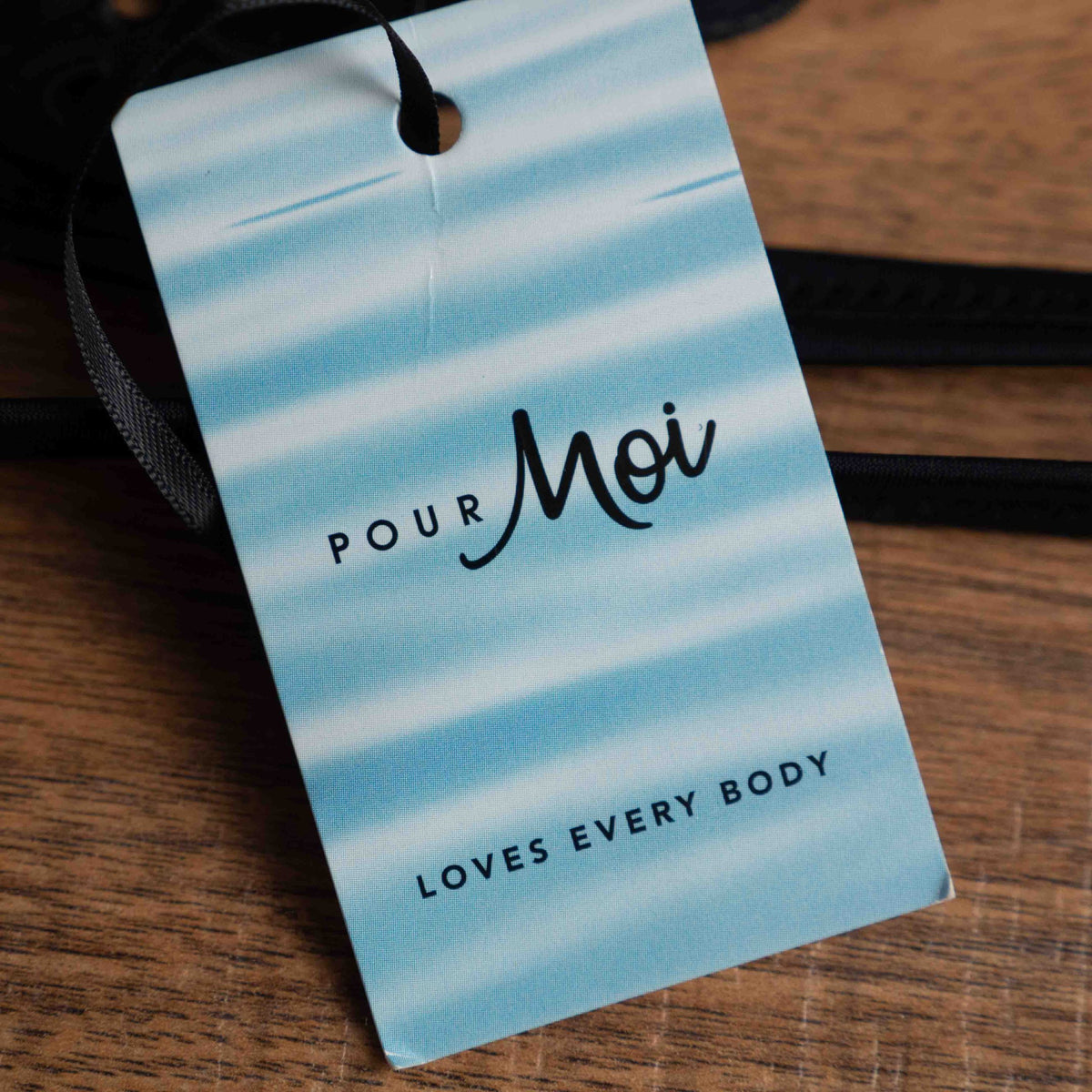 Pour Moi black bikini top with eyelet ruffle detail and adjustable straps.