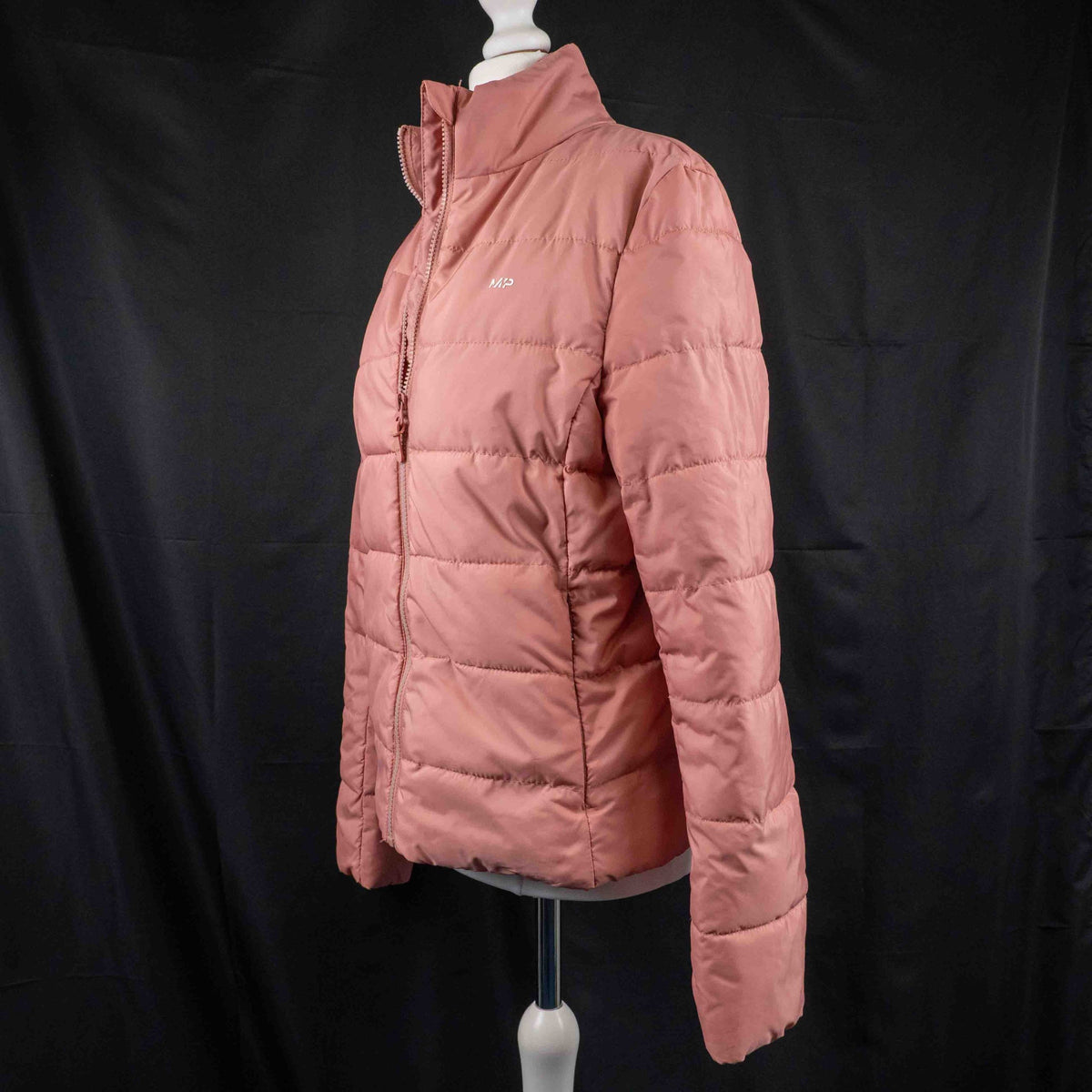 MP pink zip up puffer jacket with horizontal quilting and minimal logo on chest.