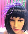 Purple fascinator with feathers and hair clip for special occasions.